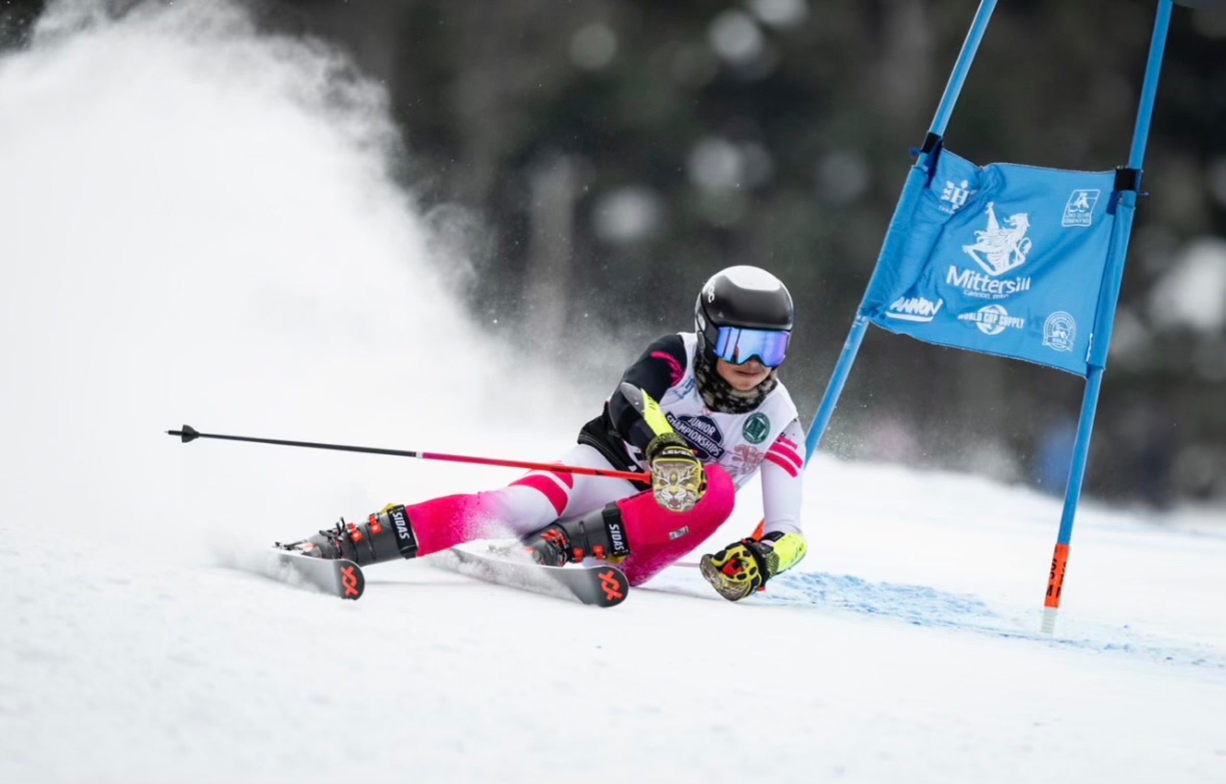 Diesel charging through a giant slalom gate in a Tomahawk race suit